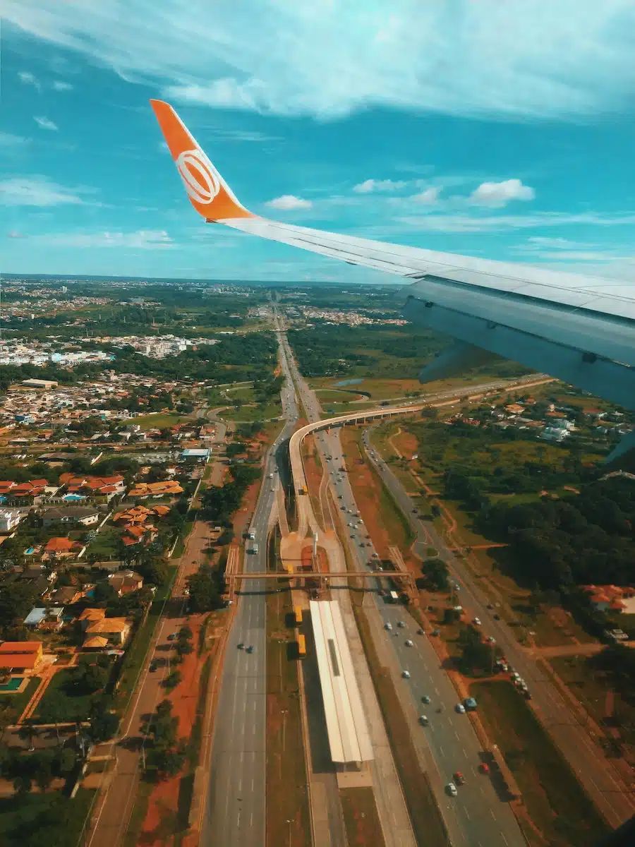 From above of junction surrounded by forest and town